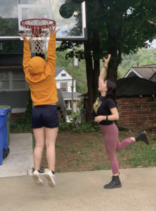 2 foster children shooting a basketball
