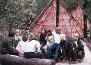 Picutre of ampers sitting around a campfire in the 1970s