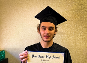 Logan with his diploma