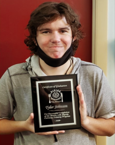 Tyler holding a plaque